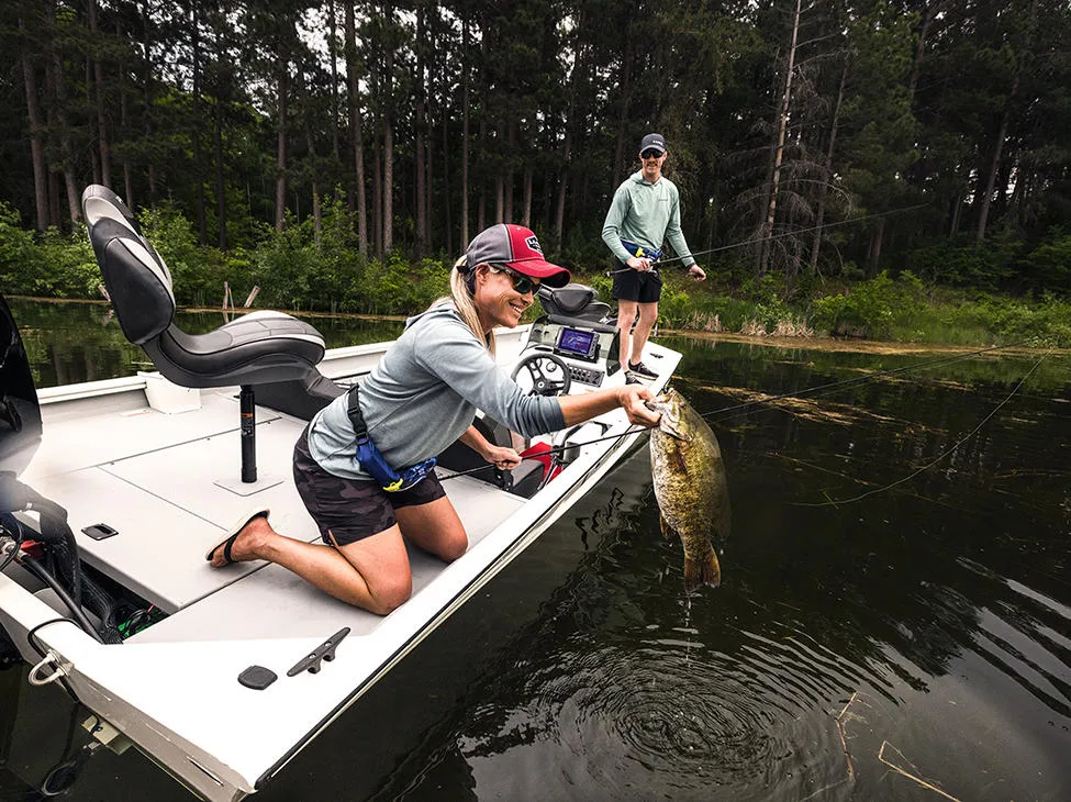 Woman catching a fish on a pretty good boat