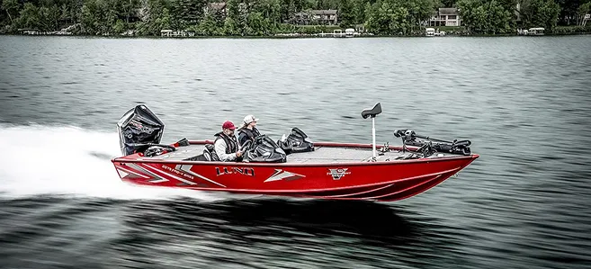 Red boat going full speed on the sea